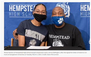 Renee Newton and Coach Lenroy Raffington sit in front of a Hempstead High School Banner with masks on